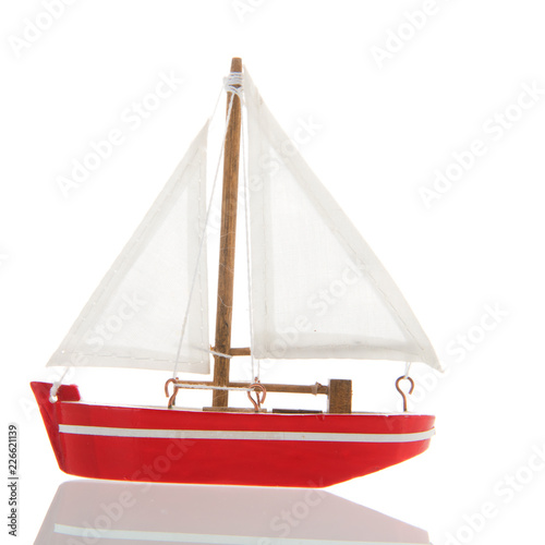 Miniature red sail boat