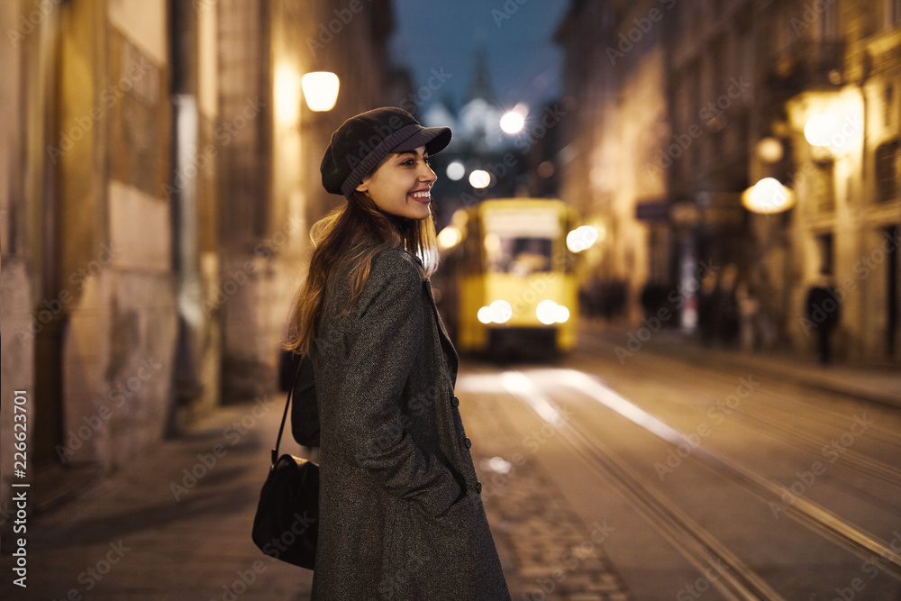 portrait of young beautiful fashionable brunette woman posing in street at autumn.