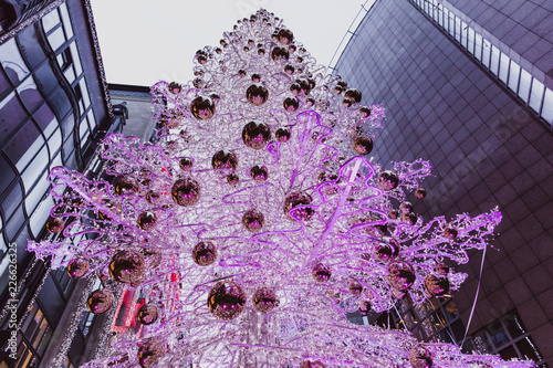 Budapest, Hungary - Glowing Christmas tree and tourists on the busy Vaci street, the famous shopping street of Budapest at Christmas time photo