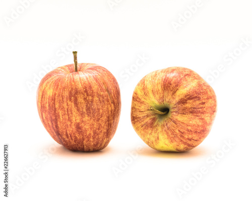 Close-up studio shot two fresh raw organic gala apples isolated on white background. Vertically striped, mottled, and overall orange in color skin. Sweet, fine textured, and aromatic flavor photo