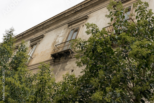 Window with balcony in shabby streets of Naples Italy
