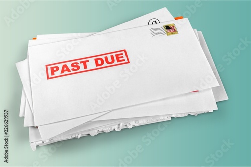 Pile of envelopes with overdue utility bills