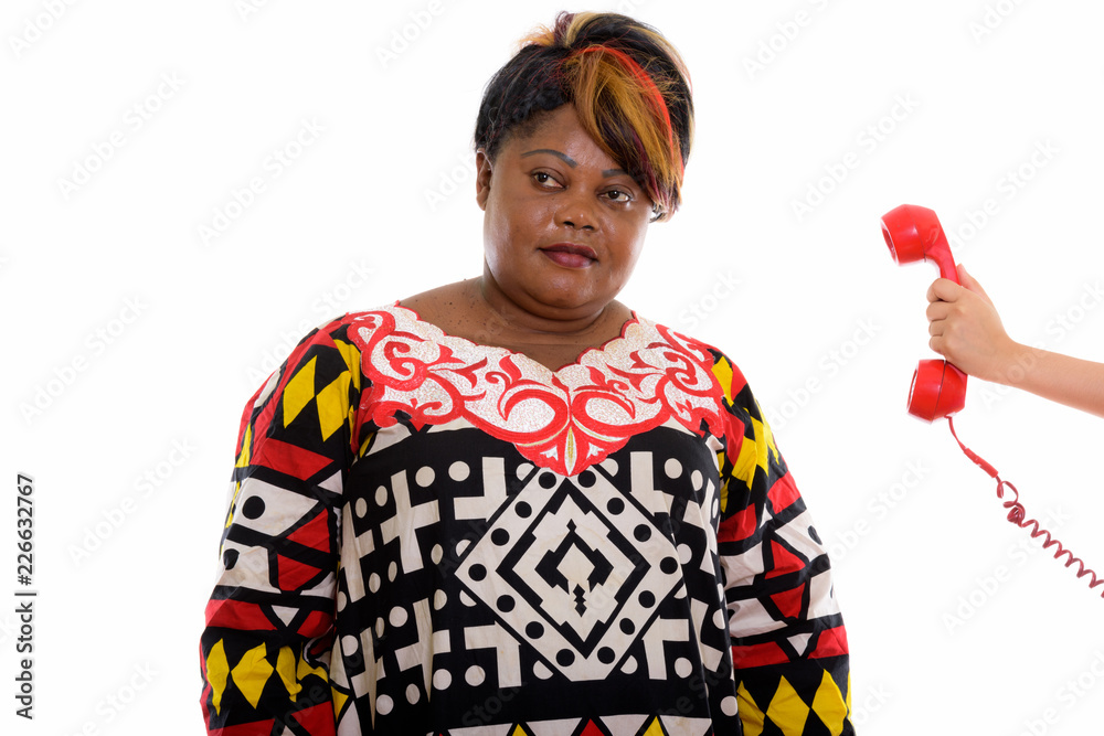 Studio shot of fat black African woman thinking with hand holdin Studio shot of fat black African woman thinking with hand holdin
