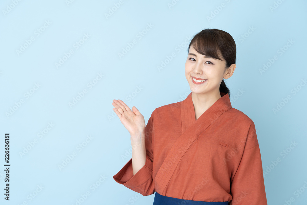 portrait of japanese style waitress isolated on blue background portrait of japanese style waitress isolated on blue background