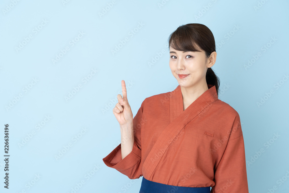 portrait of japanese style waitress isolated on blue background
