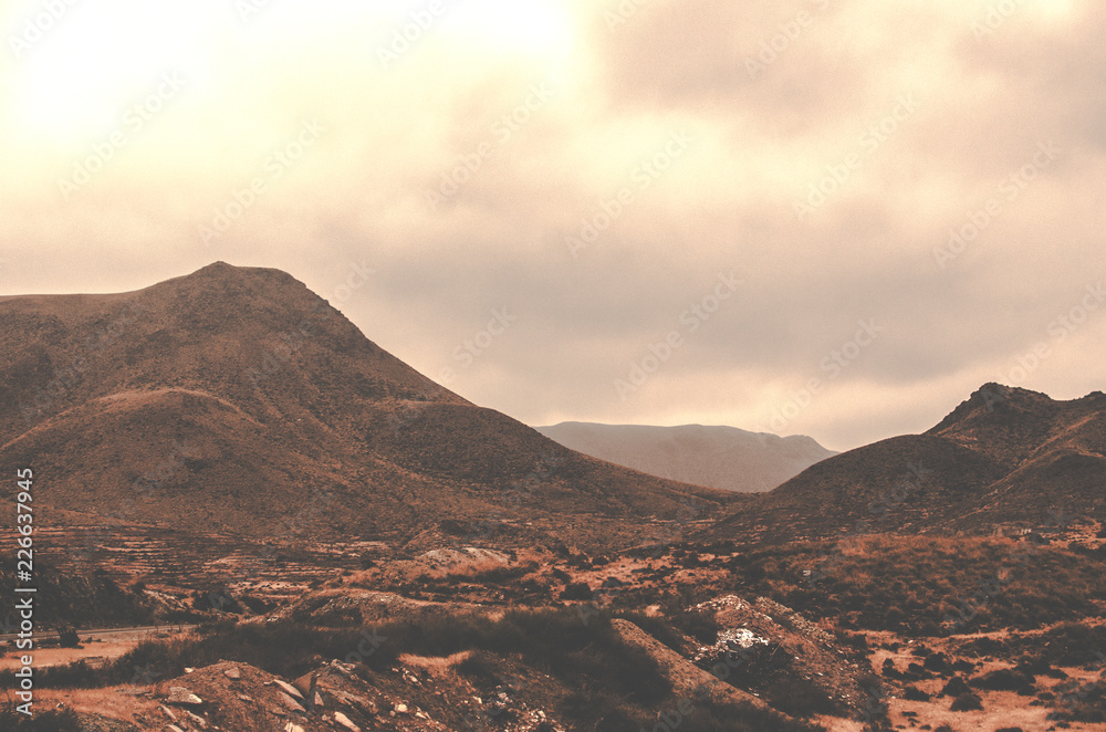 Naklejka premium Inhospitable, desert, dusty and cloudy landscape