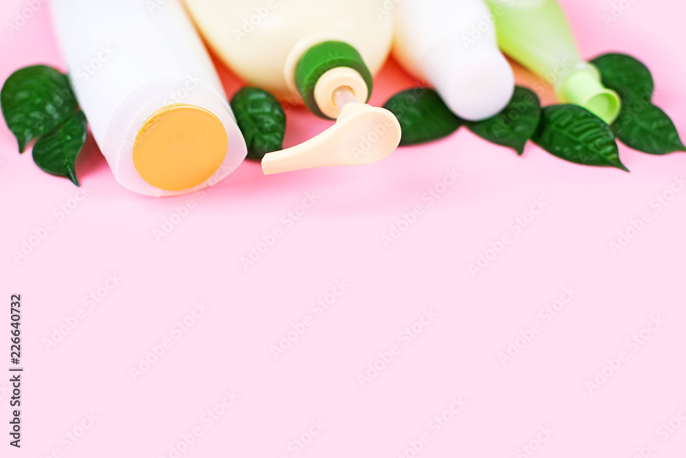 Cosmetics for hair and body care white bottles on a pink background natural organic product Copy space, selective focus