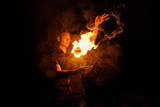 Fire show. Fakir juggles with fire Poi. Night performance. Illusion of a suspended object