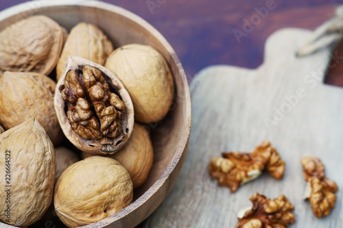 Group of walnut in wooden bowl on wood background, copy space, super food concept © sundaemorning