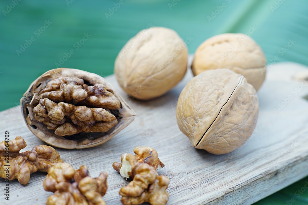 Group of walnut in wooden bowl on wood background, copy space, super food concept Group of walnut in wooden bowl on wood background, copy space, super food concept