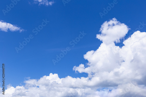 Blue sky background with white clouds, rain clouds.