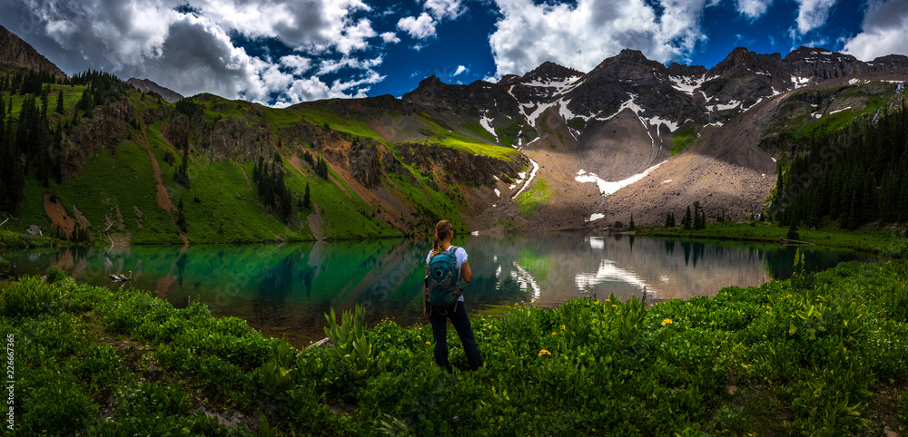 Hiker looks at Blue Lake Ridgway Colorado
