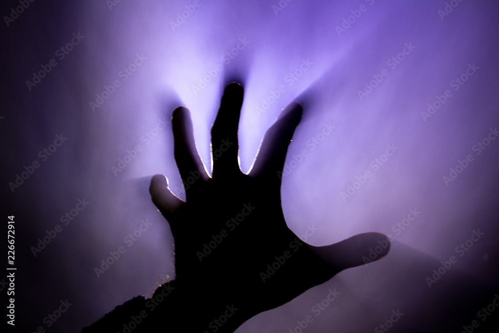 blurred hand in smoke in a fire in the harsh light of the sun blurred hand in smoke in a fire in the harsh light of the sun