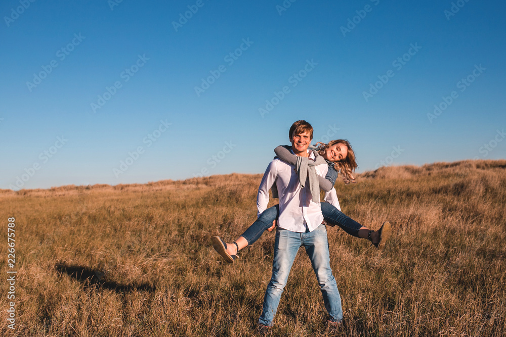 Happy young couple playing and laughing outdoors. Happy young couple playing and laughing outdoors.