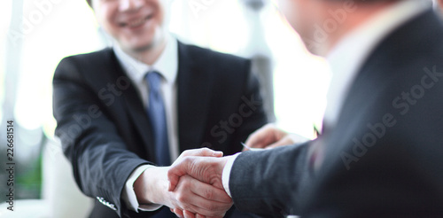 background image close-up of handshake of business partners