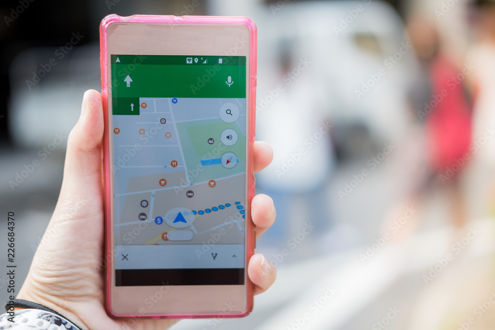 technology background hand of woman hold mobile phone with gps map on screen technology background hand of woman hold mobile phone with gps map on screen
