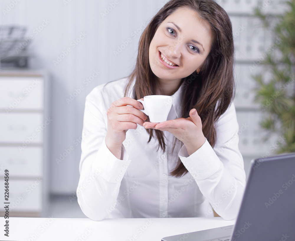 successful business woman with coffee Cup sitting at her Desk successful business woman with coffee Cup sitting at her Desk