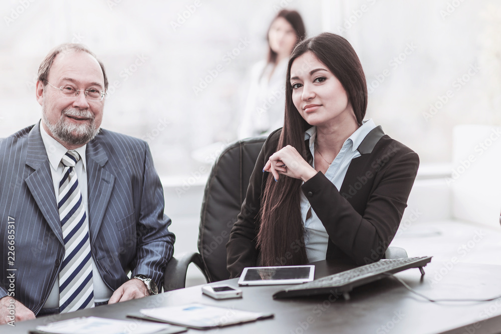 chief and his female assistant discuss the working documents for the workplace chief and his female assistant discuss the working documents for the workplace