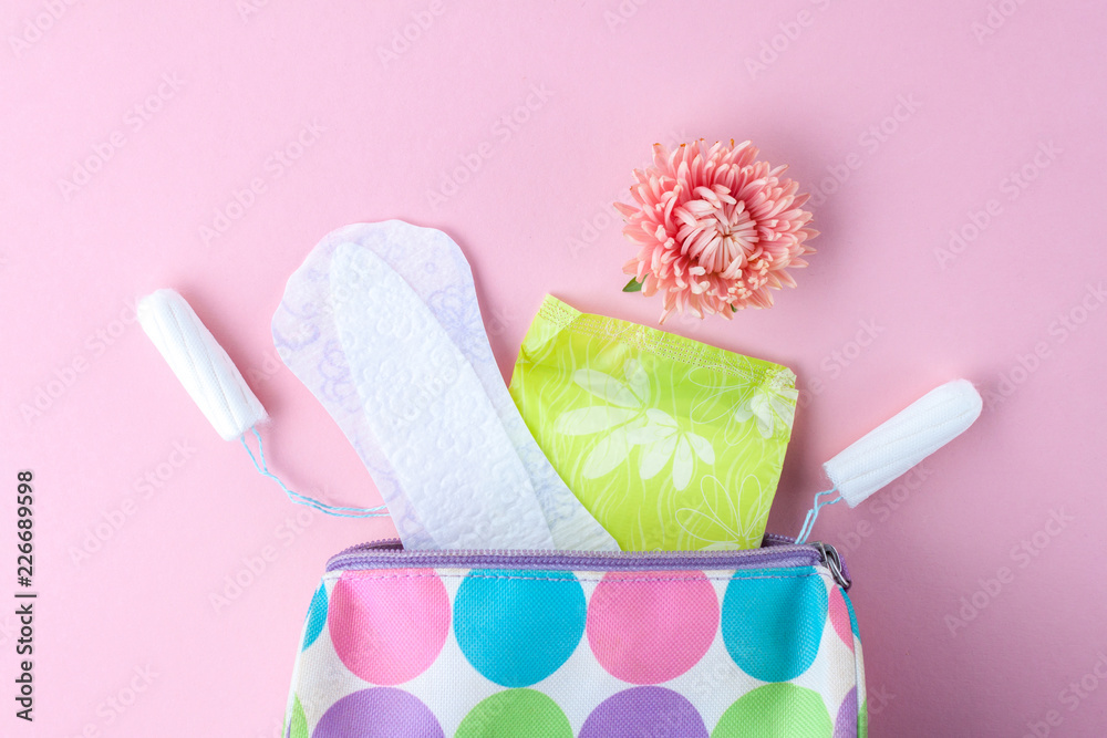 Tampons, feminine sanitary pads, flowers and women's cosmetic bag on a pink  background. Hygiene care during critical days. Menstrual cycle. Caring for  women's health. Monthly protection Stock Photo | Adobe Stock
