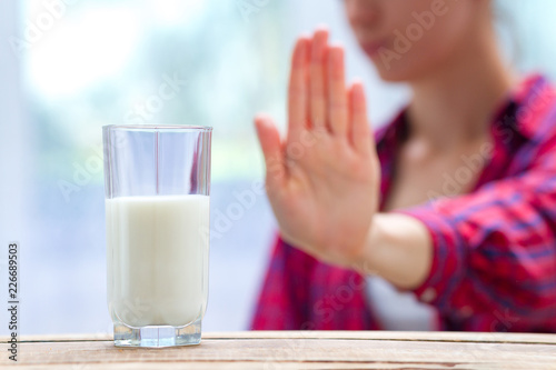 A woman feels bad, has an upset stomach, bloating due to lactose intolerance. Dairy intolerant person. Health care concept. Lactose intolerance and dairy products photo