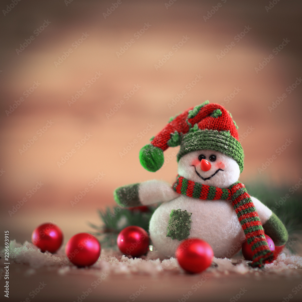 Christmas card. toy snowman on a festive background.