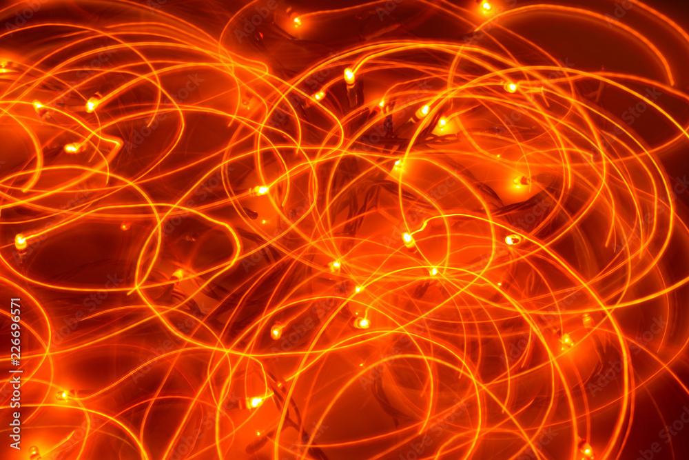 Obraz premium minimal holiday concept, garland bulbs glow in the dark on long exposure, light circles