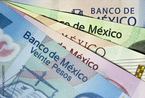 Arrangement of assorted mexican peso bills.