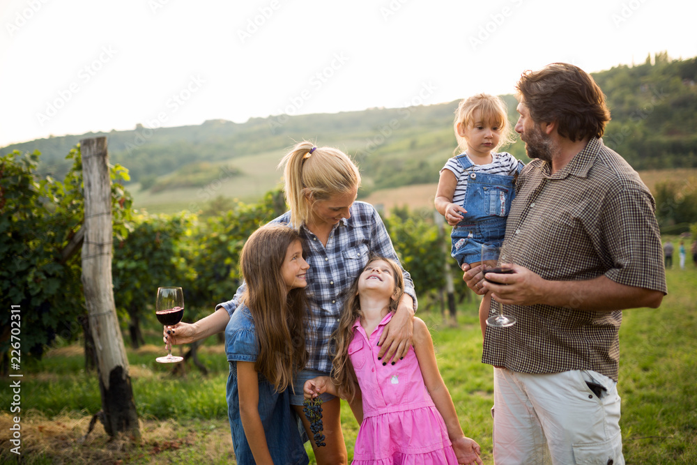 Fototapeta premium Wine grower family in vineyard