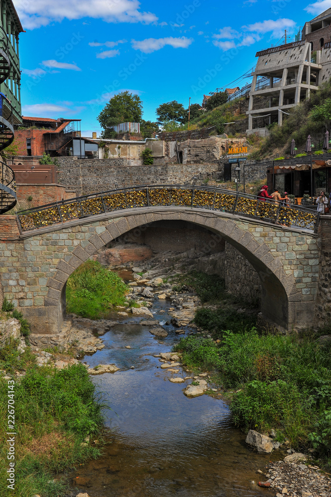 Thousands of locks hanging on an old bridge in the gorge in old city of Tbilisi.