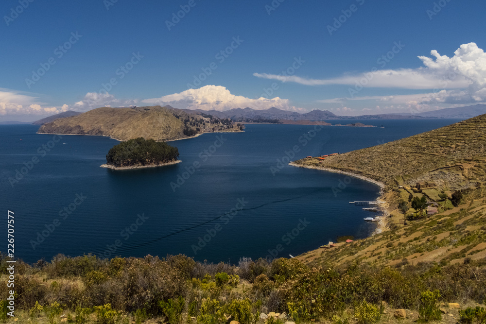 Terraced landscape of Isla del Sol with Andes mountains in the background on the Bolivian side of Lake Titicaca