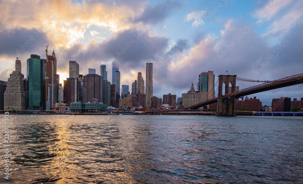 Brooklyn Bridge in New York City at  clounds sky, Skyline of downtown New York, USA
