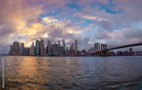Brooklyn Bridge in New York City at  clounds sky, Skyline of downtown New York, USA