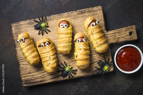 Halloween food. Scary sausage mummies in dough.