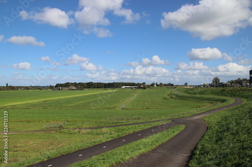 meadows of the Zuidplaspolder at Moordrecht, the lowest area of western europe in the Netherlands in wide area view with blue sky and white clouds.