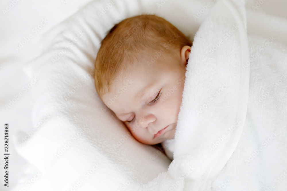 Cute little newborn baby girl sleeping wrapped in blanket Cute little newborn baby girl sleeping wrapped in blanket