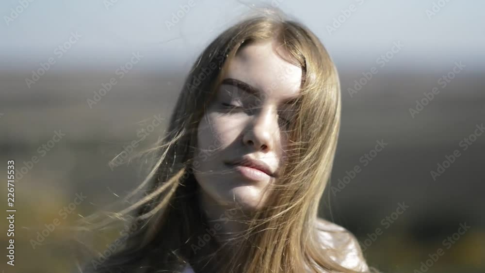 Closeup portrait of a young girl. Red hair develops in the wind. Closeup portrait of a young girl. Red hair develops in the wind.