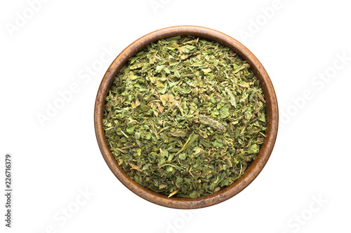 dried mint spice in wooden bowl, isolated on white background. Seasoning top view
