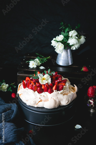 Dessert Anna Pavlova with strawberries on a black background photo