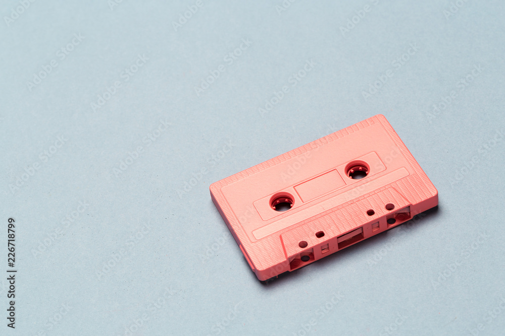One single retro audio cassette on light grey background, top view One single retro audio cassette on light grey background, top view