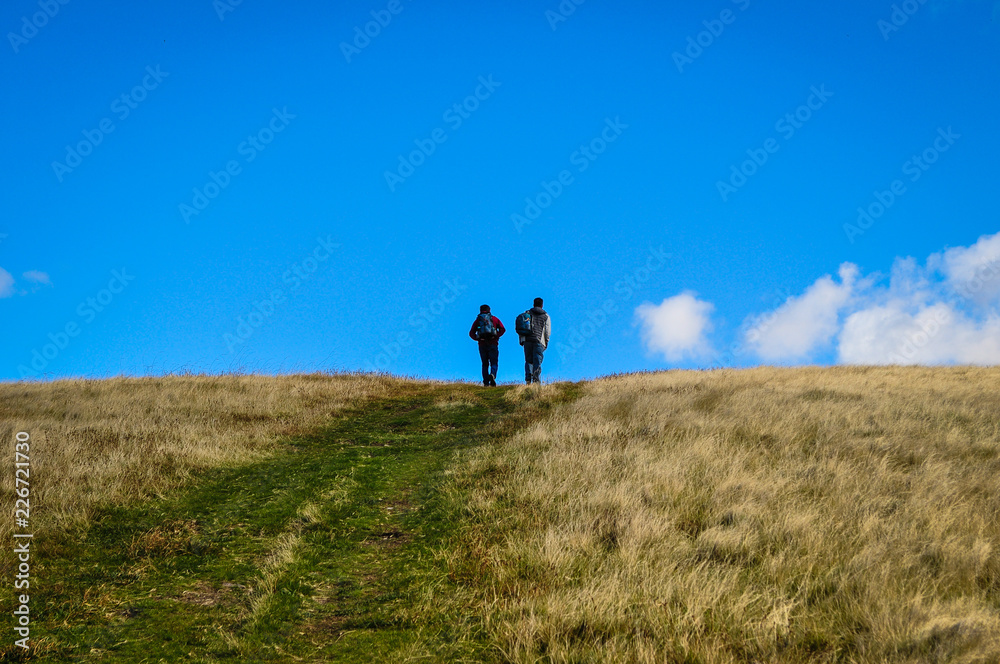 Two men hikinf from a distance