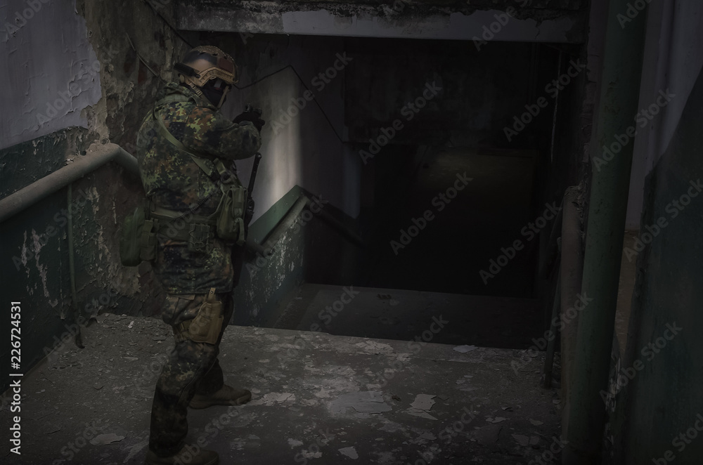 A army soldier takes aim with a pistol gun in his hands. Storming the building concept. A army soldier takes aim with a pistol gun in his hands. Storming the building concept.