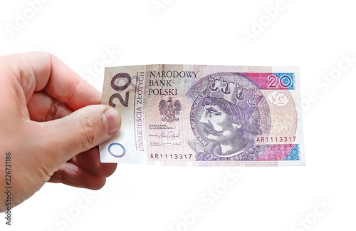 Close up on a 20 zloty banknote in a man's hand. Isolated object on white background photo