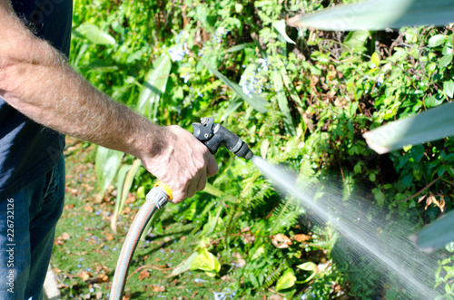Watering the garden with a hosepipe