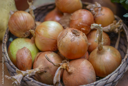 ripe golden onion in a basket