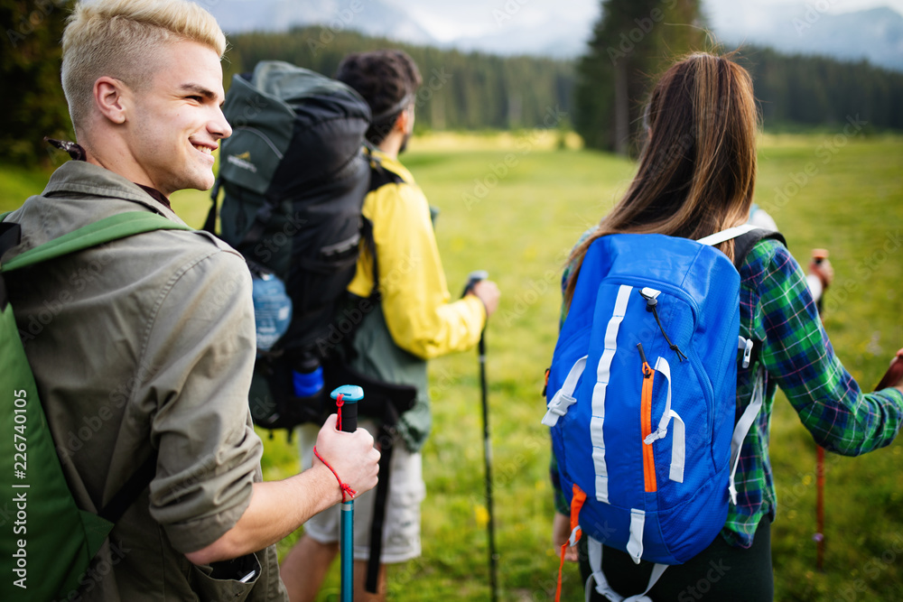 Group of friends are hiking in mountain. Young people walking through countryside. Group of friends are hiking in mountain. Young people walking through countryside.