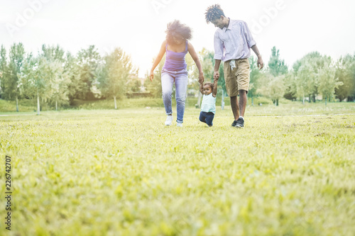 Happy black family walking in public park outdoor