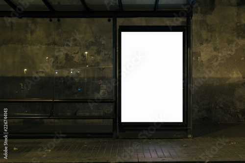 Light box display with white blank space for advertisement at bus station in night city. Mock-up design concept.