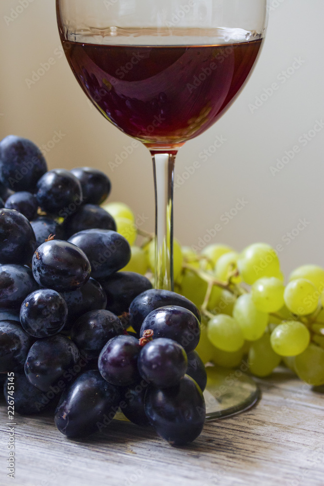 red wine with grapes close on the table red wine with grapes close on the table