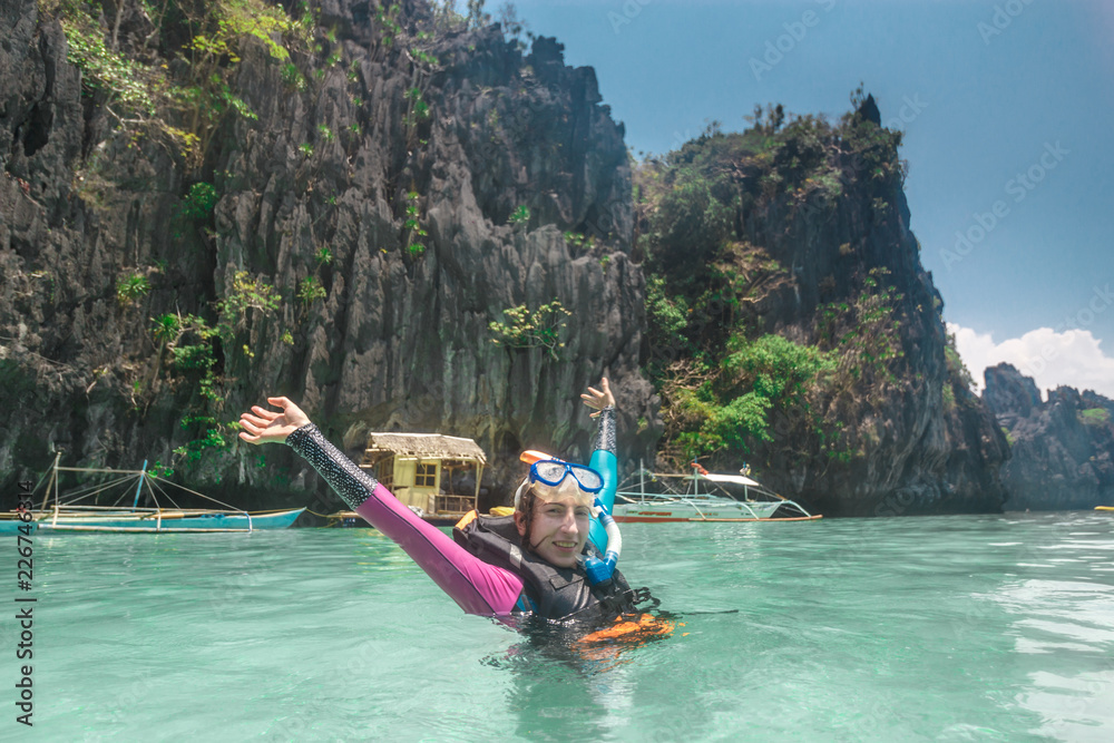 Fototapeta premium Female snorkeling underwater - Adventure travel lifestyle enjoying happy fun moment - Trip around Philippines wonders