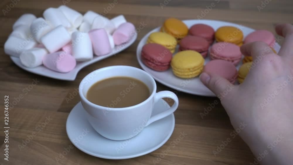 Coffee time with macaroons and marshmallows in super slow motion 